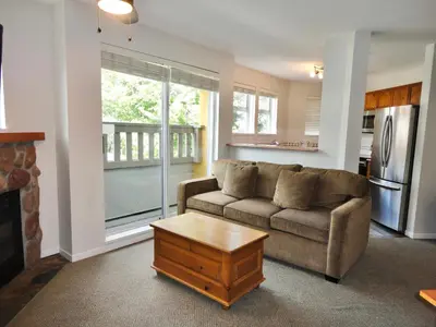 a living room with a couch and a coffee table at Bear Lodge Two Bedroom by MVA in Whistler