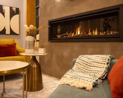 a living room with a fireplace and a couch at Alpenglow Lodge Family & Work Retreat by MVA in Whistler