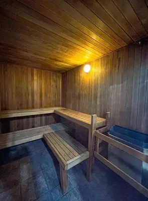 a sauna with wooden benches and a blue tub at Alpenglow Lodge Family & Work Retreat by MVA in Whistler