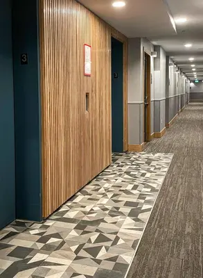 a hallway of an office building with a checkered floor at Alpenglow Lodge Large Studio with Dedicated Work Space by MVA in Whistler