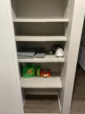 an empty closet with some food andagents on the shelves at Spacious 2-bedroom apartment in Camrose