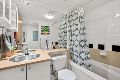 a bathroom with a sink and a toilet at Beautiful Downtown Loft with full kitchen in Vancouver