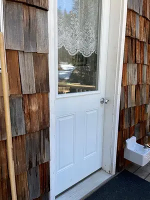a white door on a house with a window at Jade City Dog House in Jade City