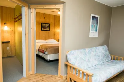 a bedroom with a bed and a couch in it at Lone Star Motel in Rossland