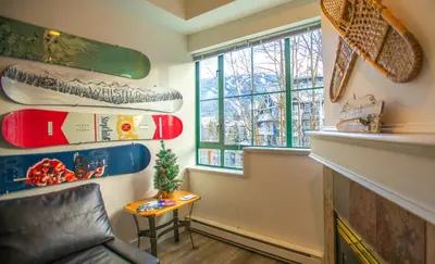 a living room with a chair and a window at The Après, Village Studio with Hot Tub and View in Whistler