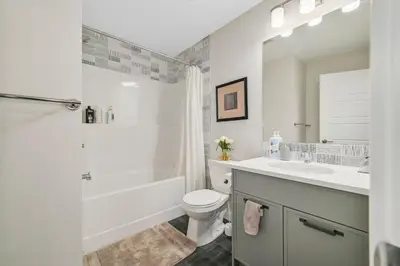 a bathroom with a sink and a toilet and a shower at Brand New 3-Bedroom Home in a Quiet Neighborhood in Calgary