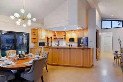 a kitchen and dining room with a table and chairs at Beachside Living Cherry Point by EMR Vacation Rentals in Cobble Hill