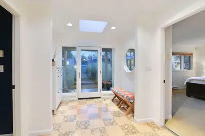 a white room with a bedroom and a bed at Beachside Living Cherry Point by EMR Vacation Rentals in Cobble Hill