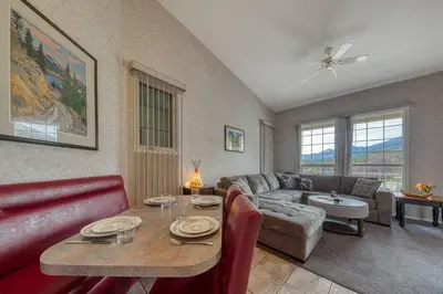 a living room with a couch and a table at Cozy Fairmont Hot Springs 1BR Condo in Fairmont Hot Springs
