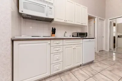 a kitchen with white cabinets and a microwave at Cozy Fairmont Hot Springs 1BR Condo in Fairmont Hot Springs