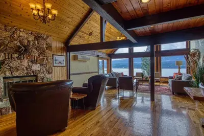a living room with a couch and a fireplace at Mountain Retreat, Panoramic Lake Views in Invermere