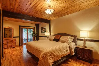a bedroom with a bed and a wooden ceiling at Mountain Retreat, Panoramic Lake Views in Invermere