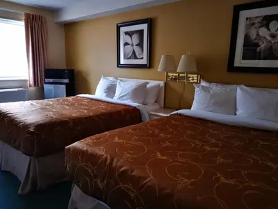 a hotel room with two beds and a window at MountainView Hotel Merritt in Merritt