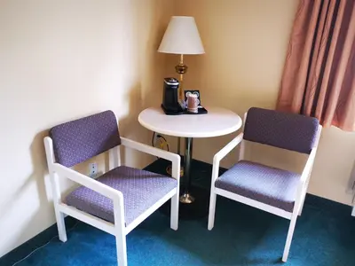 two chairs and a table in a room at MountainView Hotel Merritt in Merritt