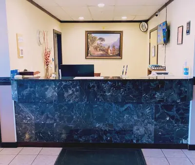 a lobby of a hospital with a blue counter at MountainView Hotel Merritt in Merritt