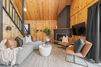 a living room with a couch and chairs and a fireplace at The Matterhorn I HotTub I Ping Pong I Chalk Wall in Fairmont Hot Springs