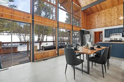 a kitchen and dining room with a table and chairs at The Matterhorn I HotTub I Ping Pong I Chalk Wall in Fairmont Hot Springs