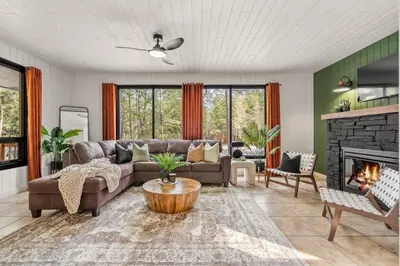 a living room with a couch and a fireplace at The Sleeping Moose I Fireplace I Pool Table I TV in Fairmont Hot Springs