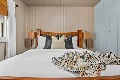 a bedroom with a bed with cheetah pillows at The Sleeping Moose I Fireplace I Pool Table I TV in Fairmont Hot Springs