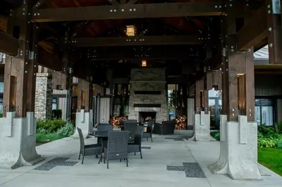 a patio with a table and chairs and a fireplace at Beautiful 2 bedroom town home in Sunrise Ridge in Parksville