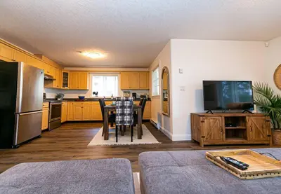 a kitchen with a table and a television in it at Cozy Renovated Oasis W Private Terrace & Parking in Victoria