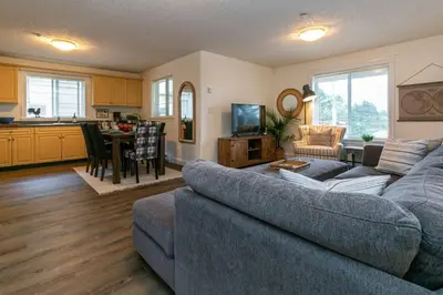 a living room with a couch and a kitchen at Cozy Renovated Oasis W Private Terrace & Parking in Victoria