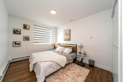 a bedroom with a bed and a window and a rug at Spacious 2bedroom FREE parking king bed close to DT in Edmonton