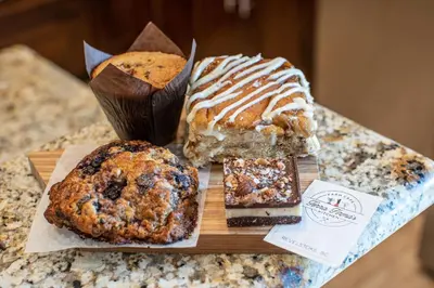 a table topped with different types of cakes and cookies at Aspen Lodge by Revelstoke Vacations in Revelstoke
