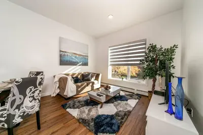 a living room with a couch and a table at Stylish Close to D/T FREE parking King Bed 2bed in Edmonton