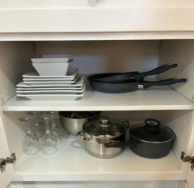 a kitchen shelf with dishes and utensils and plates at Chic Romantic3bed patio WIFI quiet retreat parking in Calgary