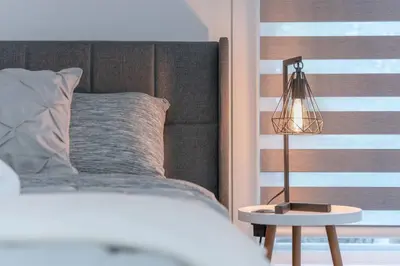 a bedroom with a bed and a lamp on a table at Chic Romantic3bed patio WIFI quiet retreat parking in Calgary