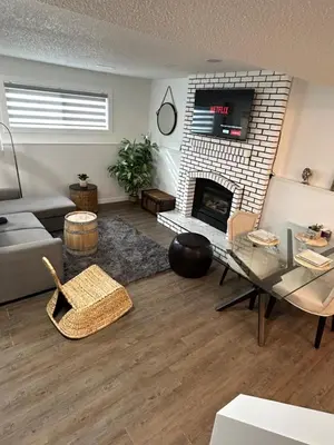 a living room with a couch and a fireplace at Chic Romantic3bed patio WIFI quiet retreat parking in Calgary