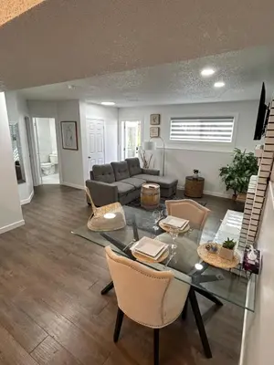 a living room with a glass table and chairs at Chic Romantic3bed patio WIFI quiet retreat parking in Calgary