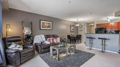 a living room with leather furniture and a table at Cozy Mountain I Hot Tub & Pool I Close 2 Lake I TV in Invermere