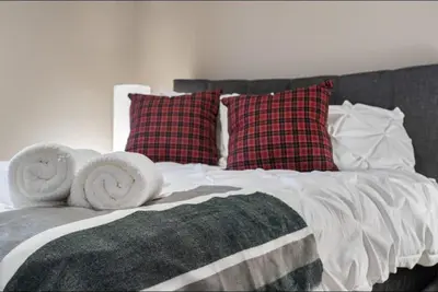 a bed with pillows and towels on top of it at Cozy Mountain I Hot Tub & Pool I Close 2 Lake I TV in Invermere