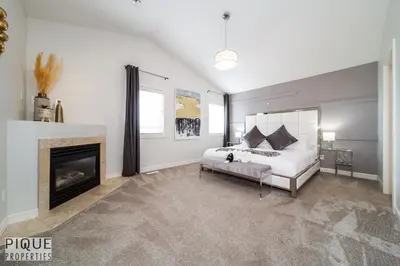 a bedroom with a bed and a fireplace at LUXURIOUS 6 Bed Home I Fireplace I near Sports Park I with Double Garage & Fast WiFi! in Edmonton