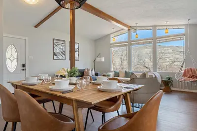 a dining room with a wooden table and chairs at Timber Valley I HotTub I PingPong I Sleep 14 I BBQ in Drumheller