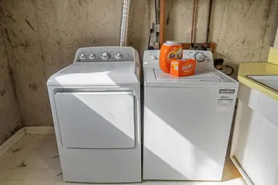 two white appliances in a kitchen next to each other at Timber Valley I HotTub I PingPong I Sleep 14 I BBQ in Drumheller