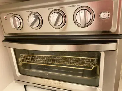 a silver oven with its door open in a kitchen at lovely home in Calgary