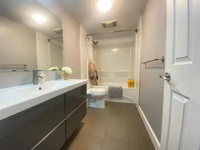 a bathroom with a white sink and a toilet at lovely home in Calgary