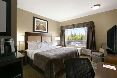 a hotel room with a bed and a window at Ramada by Wyndham Conklin in Conklin