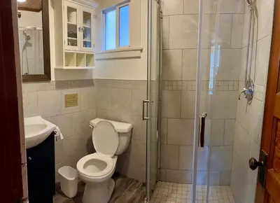 a bathroom with a toilet and a shower at Banff Beaver Cabins in Banff