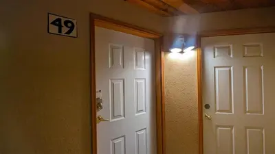 a hallway with a door and a light next to it at Snow Creek Village #49 in Sun Peaks