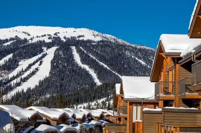 a ski resort with a mountain in the background at Woodhaven #19 by Bear Country in Sun Peaks