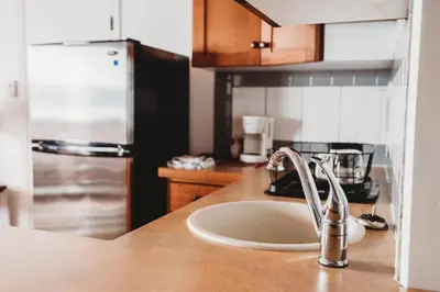 a kitchen with a sink and a counter top at The Oceanfront Hotel in Sointula