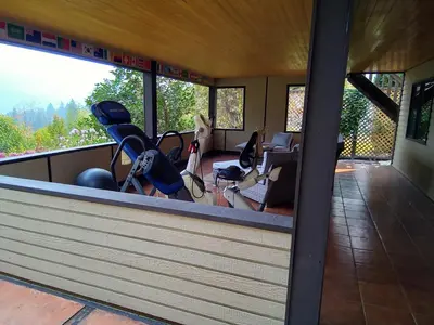 a gym with cardio equipment on the roof of a house at Hannie's Gasthuis in Blind Bay