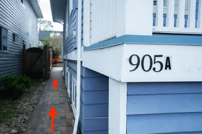 two red arrows are pointing to the address of a house at Lovely 1BR Secondary suite with Separate entrance in New Westminster