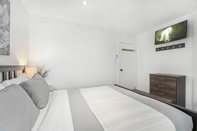 a bedroom with a bed and a tv on a wall at 3BR in Whistler Creek Ridge, Ski In, Ski Out, Private Hot Tub, Wood Burning Fireplace, Private Garage in Whistler