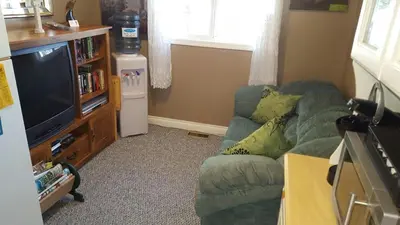 a living room with a couch and a television at The Grateful Bed B'n'B in Prince George