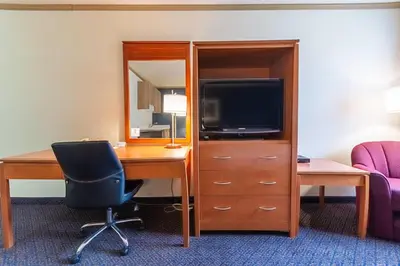 a hotel room with a desk and a tv at Days Inn by Wyndham Drayton Valley in Drayton Valley